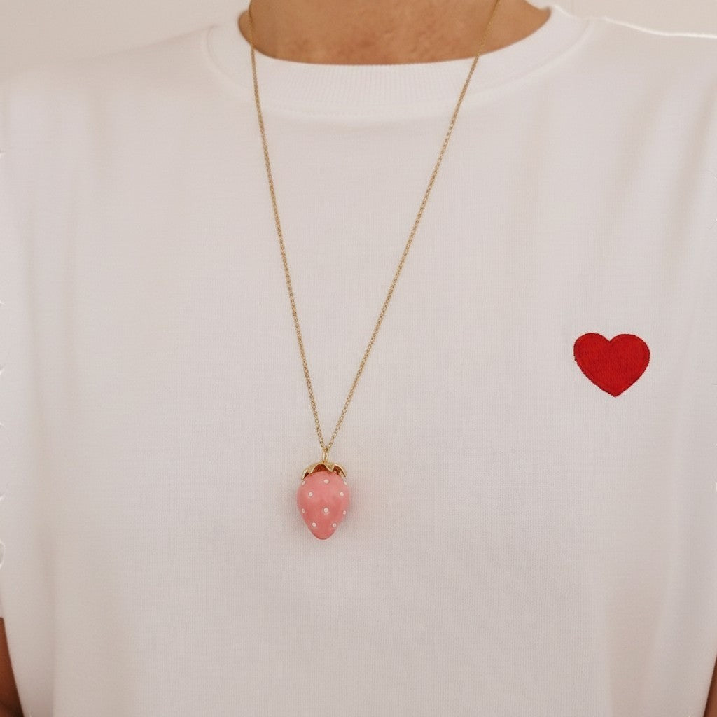 ZOA HANDMADE powder pink strawberry pendant necklace with pearl seeds and gold stem on a long stainless steel chain.