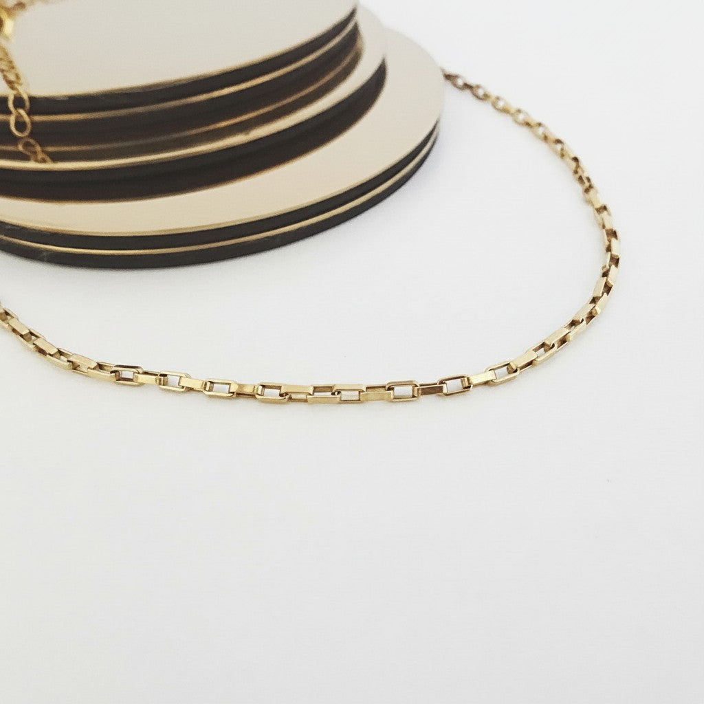 ZOA HANDMADE gold-tone stainless steel link choker necklace with square links, designed to sit close to the neck.